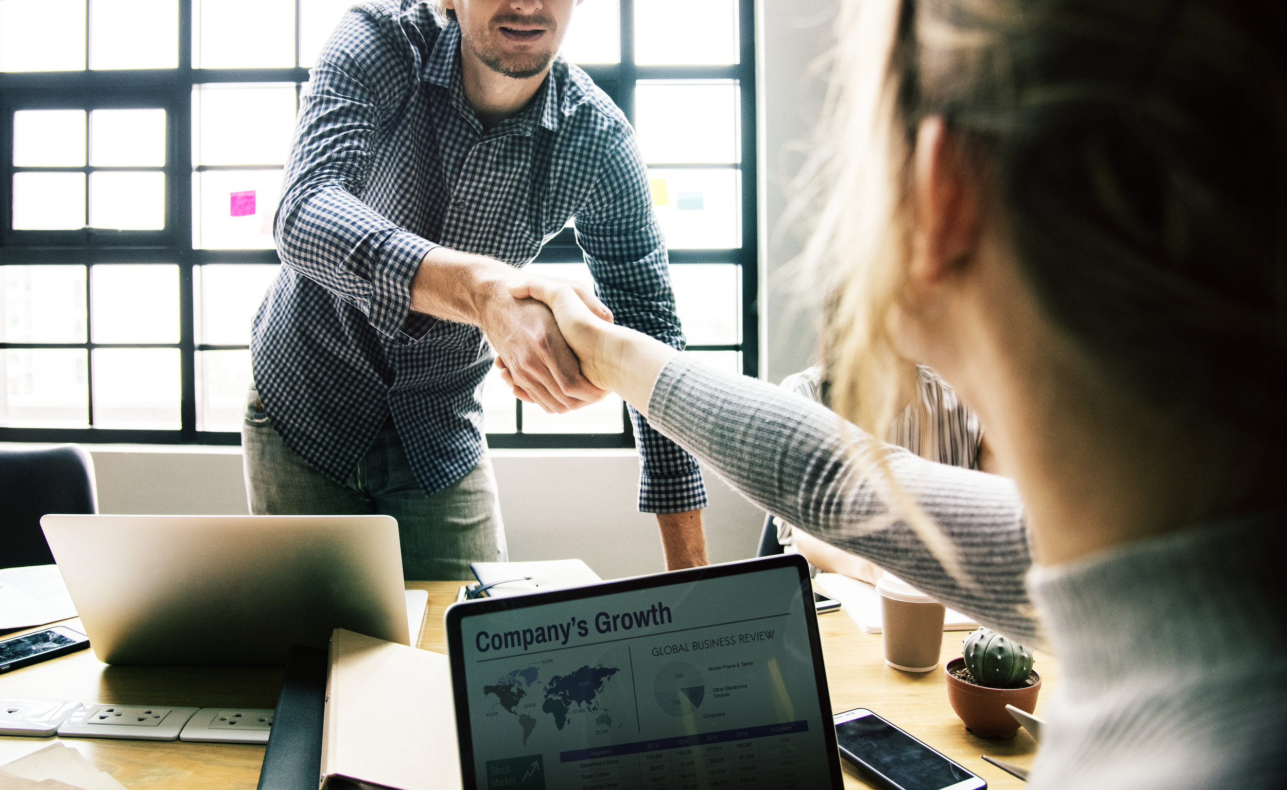 A femal SDR shaking hands with a coworker