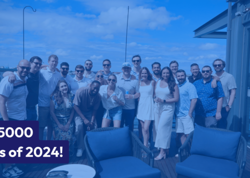 Inc. 5000 Class of 2024 group photo on a rooftop patio with a clear sky and cityscape in the background