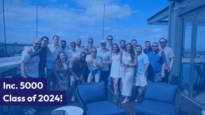 Inc. 5000 Class of 2024 group photo on a rooftop patio with a clear sky and cityscape in the background