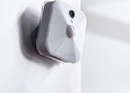 Smart security camera mounted on a wall, capturing video footage inside a home.
