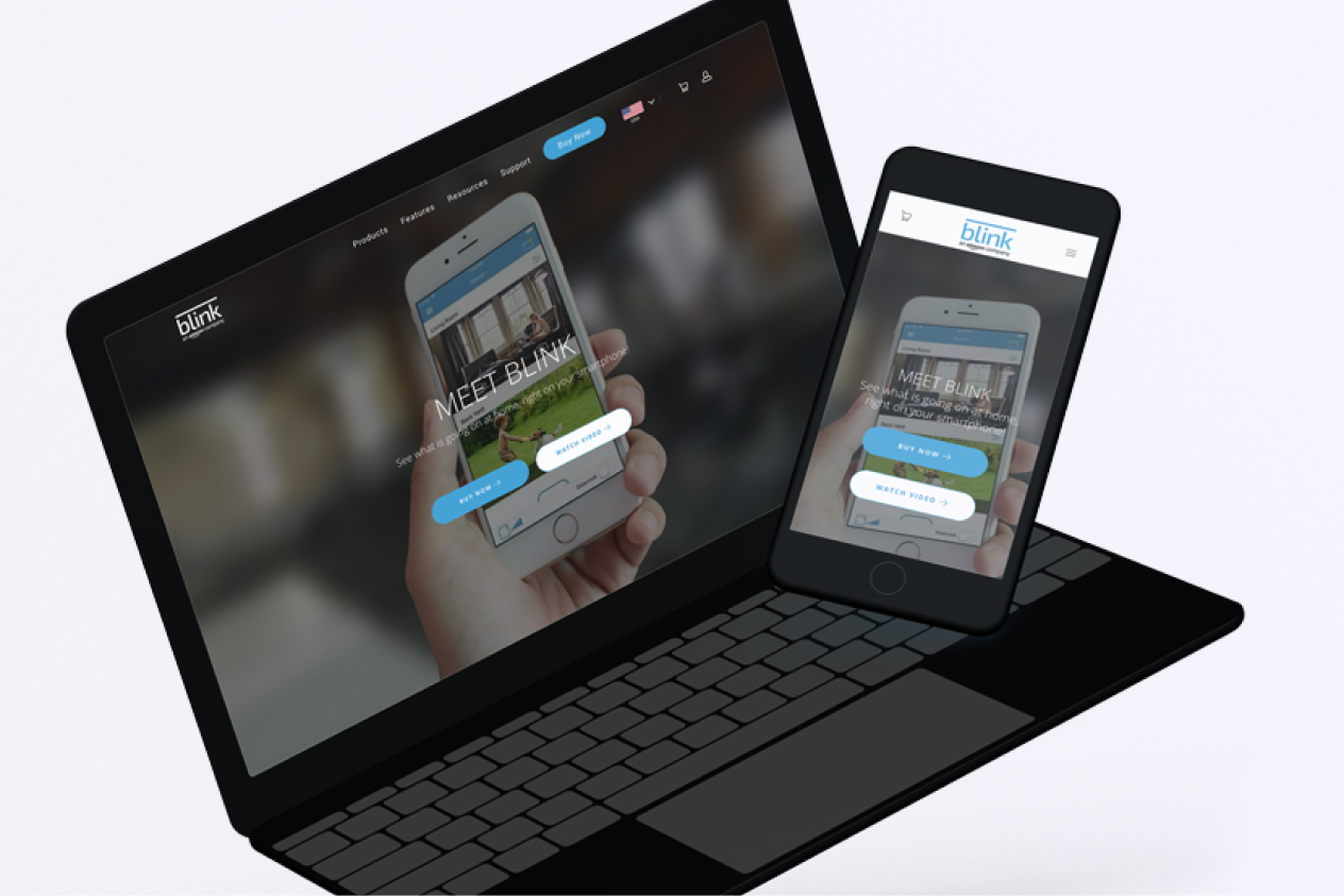 Laptop and smartphone displaying the same website on their screens against a blurred background.