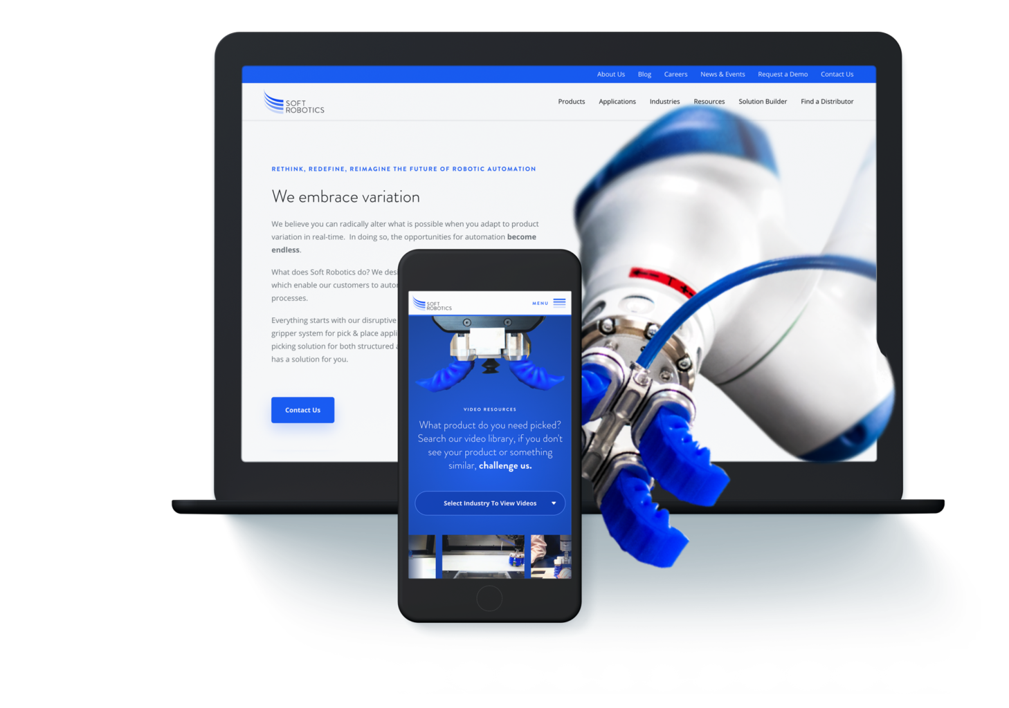 Computer and smartphone displaying a robotics technology website with a robotic arm on the screen.