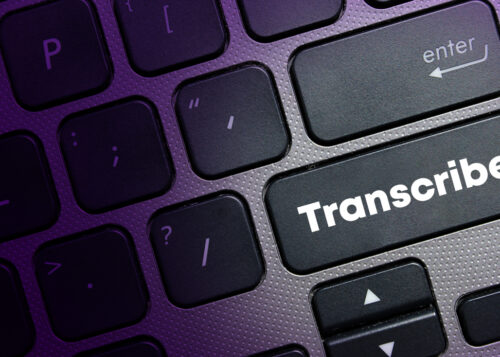"Close-up of a keyboard with a key labeled 'Transcribe' instead of the usual Enter key."