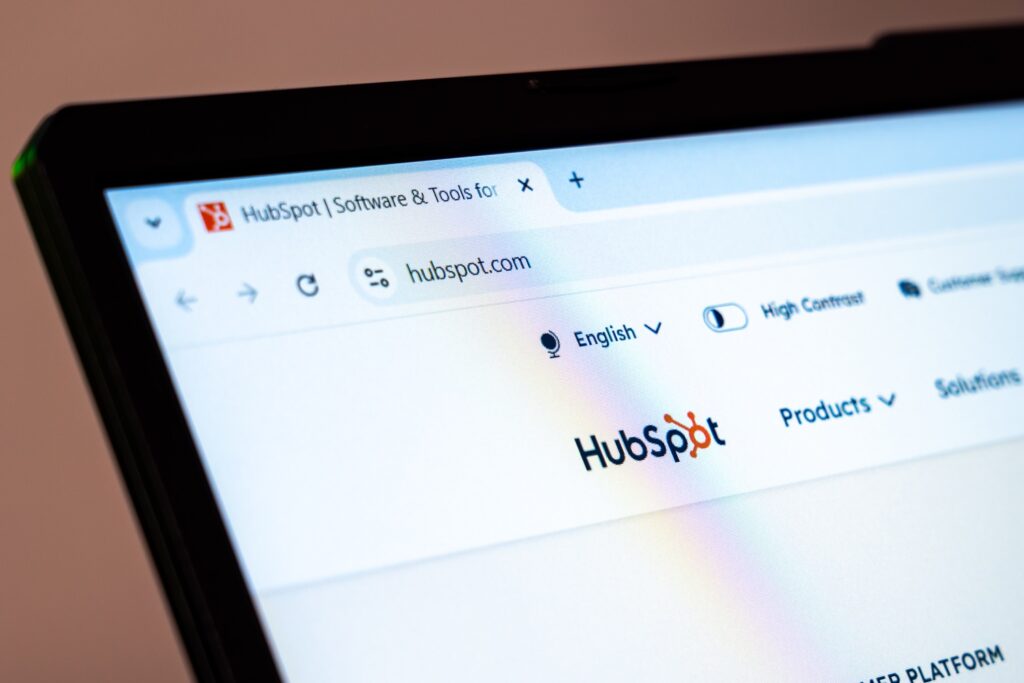 Laptop screen displaying HubSpot website homepage with URL hubspot.com.